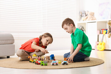 Naklejka premium Cute little kids playing with toys on floor indoors