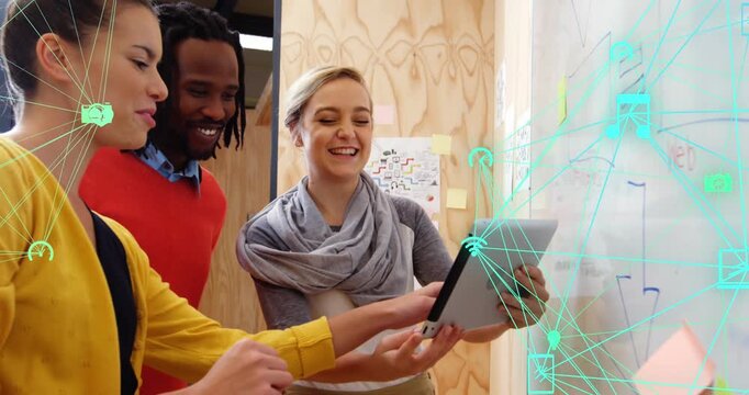 Two business executives are discussing over a digital tablet in their office