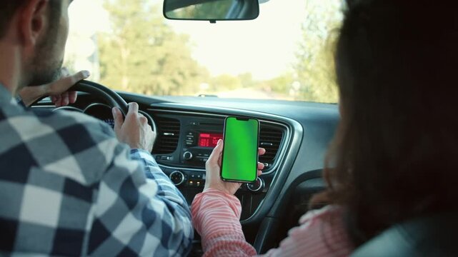 Couple using digital map application while travelling together. Slow motion