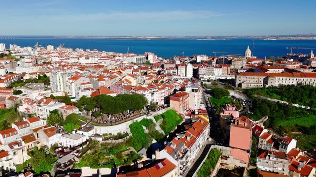 Establishing shot of Lisbon rooftops with hilltop viewpoint in Graca. Miradouro da Senhora do Monte in Lisbon, Portugal. 
