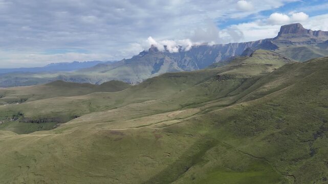 Aerial Plateau Summit Under Brooding Clouds, Jagged Escarpments And Flat Mesa Tops, Winding Trail Along Ridge,