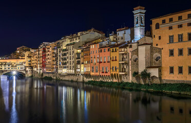 Fototapeta premium Cityscape with medieval gothic buildings by the famous bridge of Ponte Vecchio on Arno River in Centro Storico, Florence, Italy after sunset at night