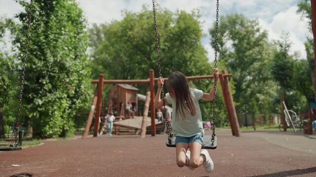 Determined white daughter pumping swing park, energetic leg pumps, braided hair, denim shorts, focused expression, rhythmic motion, aspiring young athlete vibe, playful practice under trees