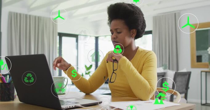 Animation of media icons over businesswoman using computer
