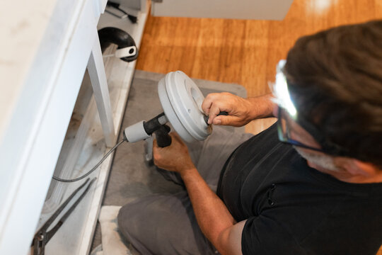 A plumber uses a drain snake, or auger, to clear a blockage from a pipe, water supply, installations, garbage disposal repair, drain cleaning
