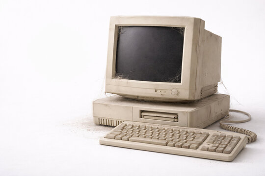 Dusty Old Vintage Computer with Cobwebs on White Background Copy Space