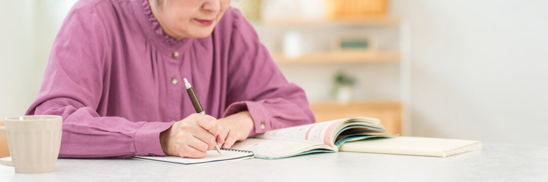Senior women studying for qualifications at home (correspondence courses, distance learning, dementia prevention)