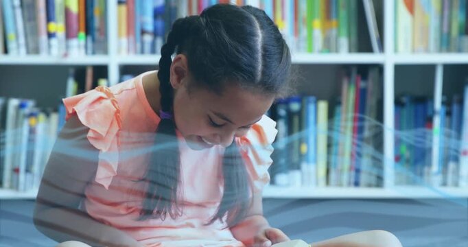 Girl opening book, turning pages, leaning in to follow story in education with blue wave passing