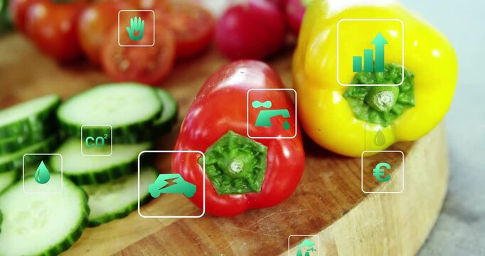 Red and yellow peppers with cucumber centering while frame cueing teal icons annotating eco metrics
