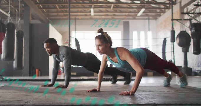 Starting low, man and woman partners performing synchronized push-ups, keeping cores engaged