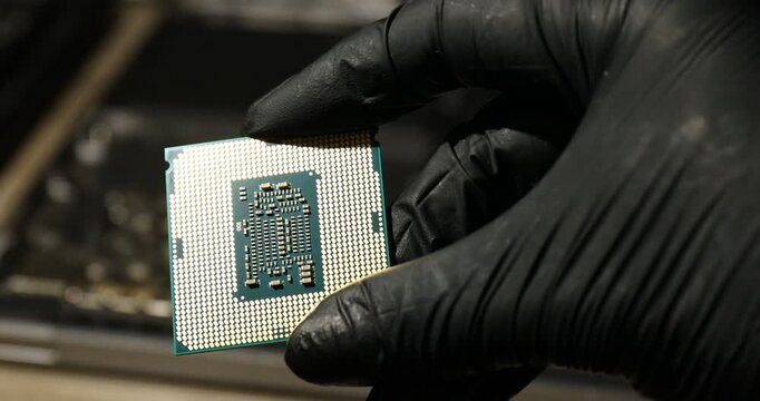 Man with central processing unit of laptop at table, closeup