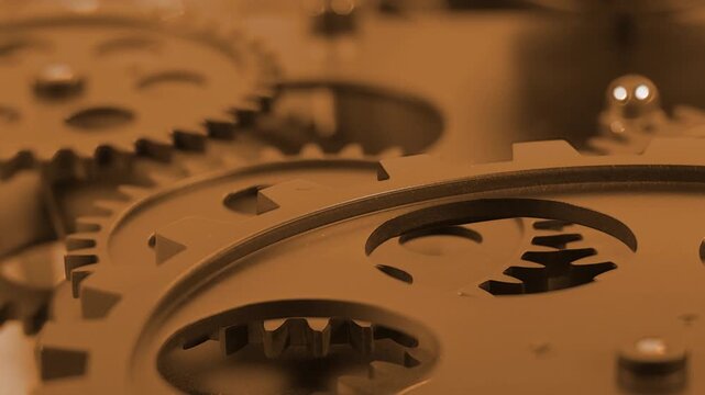 Abstract macro shot of golden mechanical gears with shallow depth of field and warm lighting cinematic industrial background representing precision motion technology and luxury concepts
