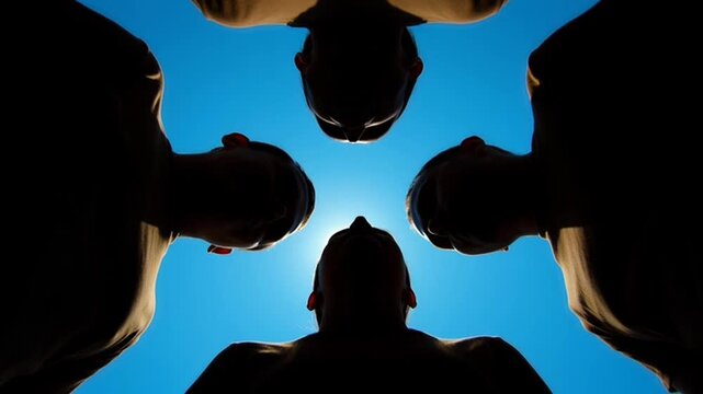 Group of people standing in circle.