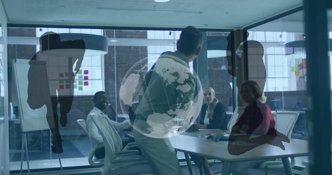 Animation of globe and rugby players silhouettes over diverse businesspeople discussing at office