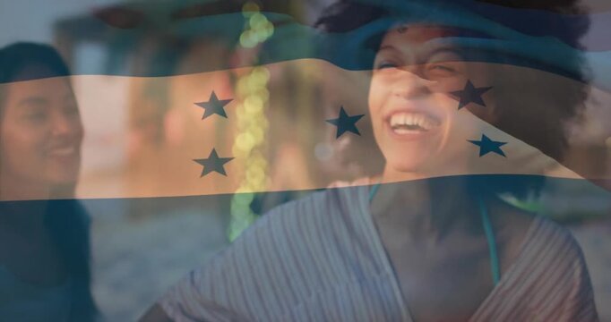 Enjoying outdoor gathering with Honduras flag animation over smiling people