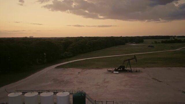 Aerial View of Oil Pump Jack in Rural Field After Sunset