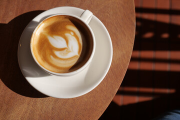 Coffee cup on table with coffee art design © Towfiqu Barbhuiya 