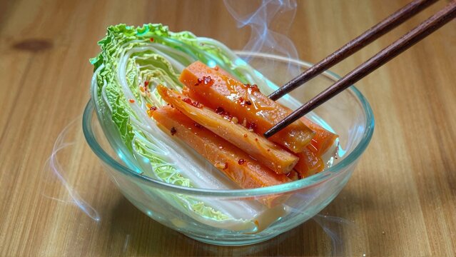 Steaming bowl of bokchoy and spicy crabsticks