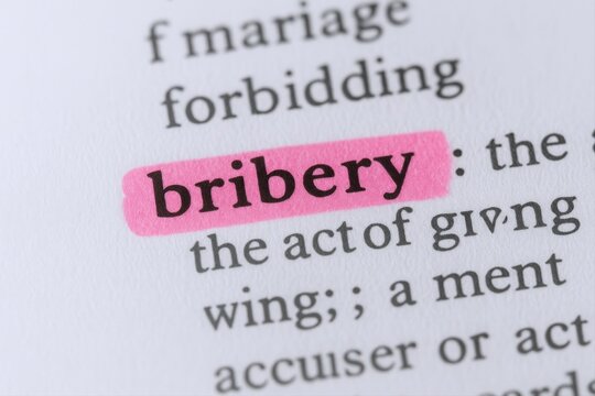 Bribery Definition Highlighted in Dictionary: Illegal Acts, Corruption, Ethics and Business Concept