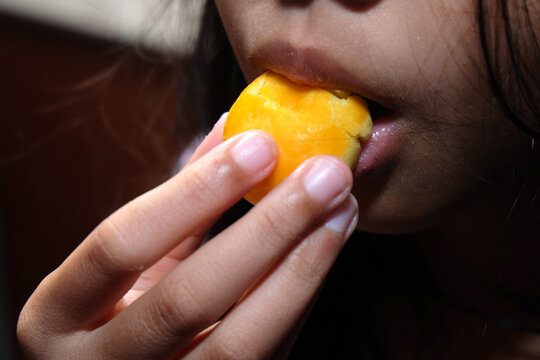 candid shot showing a person taking a bite of the same golden pastry.