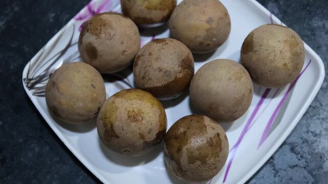 Ripe Sapodilla Fruits Arranged on Plate in 4K Horizontal Close Up
