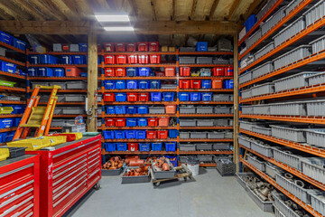 Organized Industrial Workshop Storage with Color-Coded Bins and Shelving System