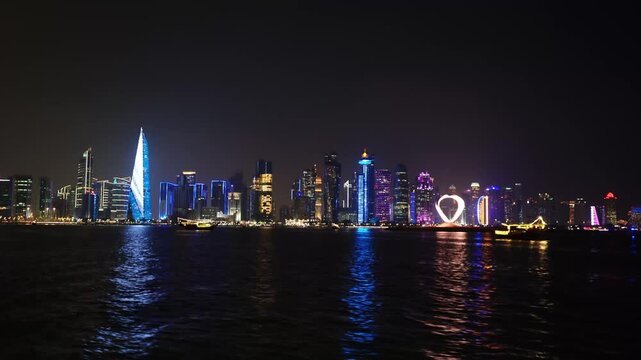 Doha skyline at night with colorful city lights and reflections