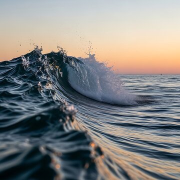 Ocean wave crashing at sunset scenic waterscape with calm horizon