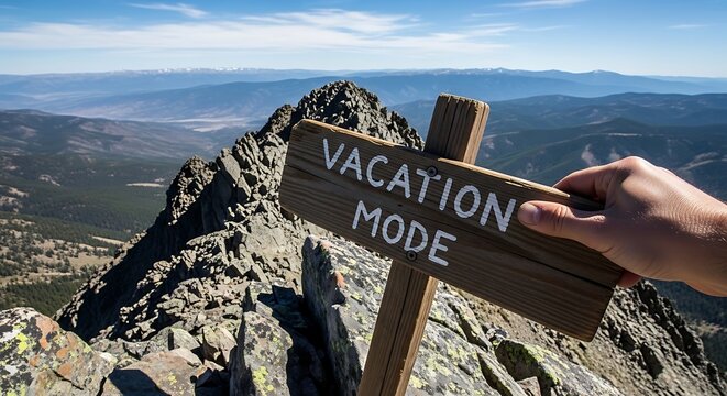 Hand holding vacation mode sign mountain.