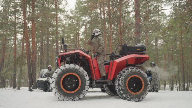 Red atv in snowy forest helmeted rider navigates pine trail, large studded tires throwing snow, cold overcast light, engine rumble, winter gear, offroad guide vibe, extreme outdoor adventure