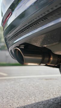 Car exhaust pipe, vehicle emissions and air pollution, vertical footage