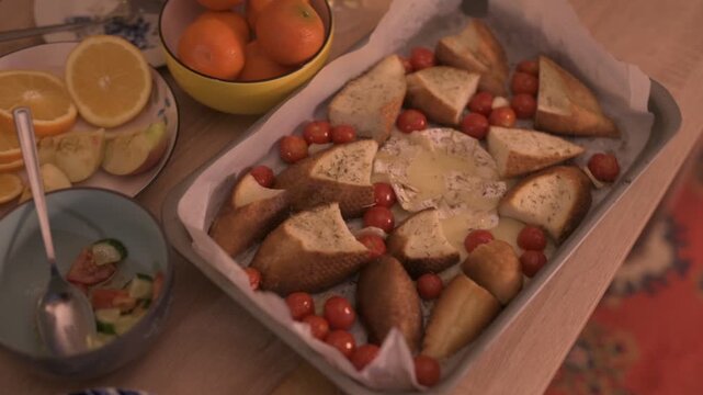 Baked Camembert, mandarins, and salads&mdash;the New Year's table.
