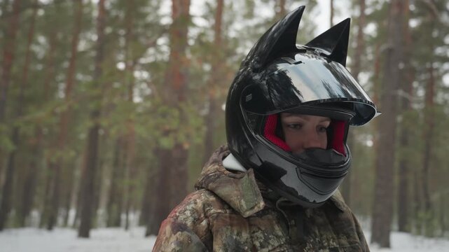 White drivers at snowy forest beside utv performing preride checks and gear loading, helmeted pair inspect doors and windshield, secure cargo and adjust straps, blue utility vehicle with roll cage