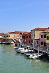 Obraz premium Ponte San Martino (San Martino Bridge) and Canale di San Donato (San Donato Canal) viewed from Ponte San Donato (San Donato Bridge) in Murano, Italy