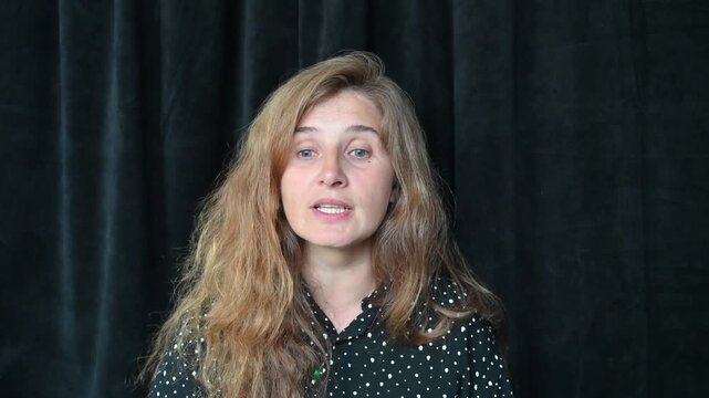 Portrait of a girl with long hair on a black background,