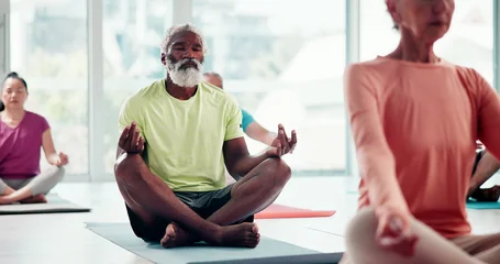 Fototapeten Lotusblume Balance, meditation and senior man in yoga class for awareness, inner peace or wellness. Exercise, mindfulness and zen with old person on floor in studio for holistic activity, development or health  © peopleimages.com