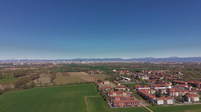 Urban Expansion into Rural Landscape: An aerial view captures the gradual encroachment of urban development onto a verdant countryside.