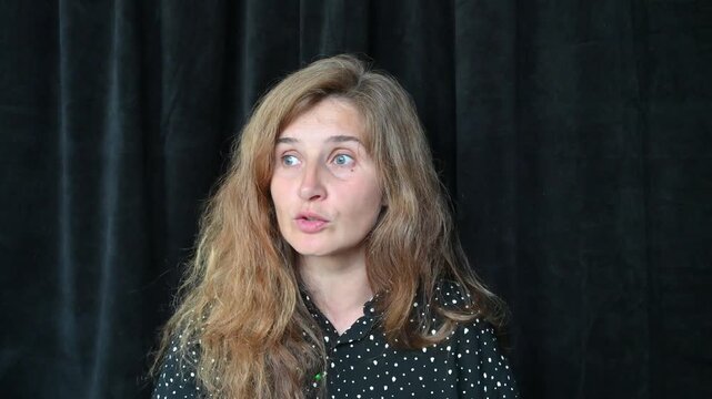 Portrait of a girl with long hair on a black background,
