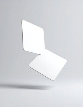 Two white cards floating in mid-air against a gray background