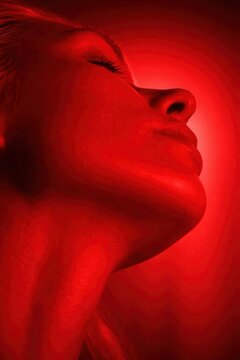 Woman face illuminated by red light therapy for skincare and wellness treatment
