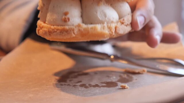 Close-up footage of delicious cream puff pastry sandwich with nuts and filling.