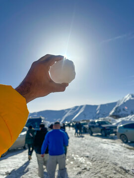 man holding a snow ball in Gudauri