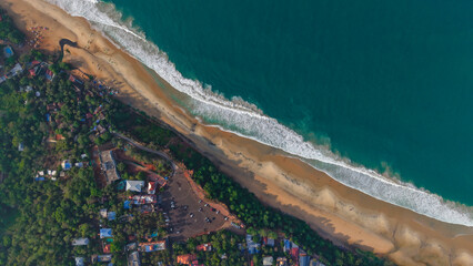 Aerial top-down view of Varkala cliff beach and Arabian Sea, Kerala, India - Tropical coastline with turquoise water © Kamesh
