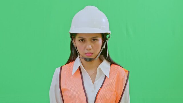 A tight shot of a female engineer with a serious and focused expression, observing site progress intently. Professional look reflecting competence and responsibility.