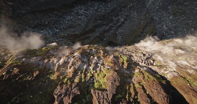 Ambrym Island volcano crater surface vent fuming steam and gas smoke from panoramic drone flight view, dramatic active volcanic landscape in Vanuatu showcasing raw geothermal power and rugged terrain