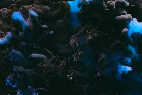 Abstract colorful blue smoke on black background. Moving flow of paints, fluid liquid art, space sky