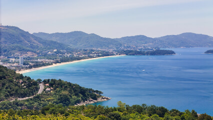 Naklejka premium An aerial photograph of Karon Beach near Patong on Phuket Island, Thailand. Taken from Freedom Beach, Phuket, Thailand at 10:00 AM, marking the start of summer sunbathing.