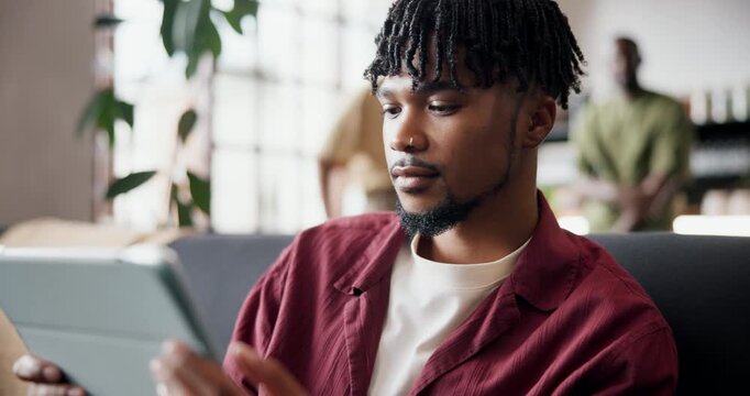 Tablet, shake head and man in home, frustrated for online gambling and error 404 for website. Apartment, tech and person on couch, rejection or email for loss on bet, network or fail on competition