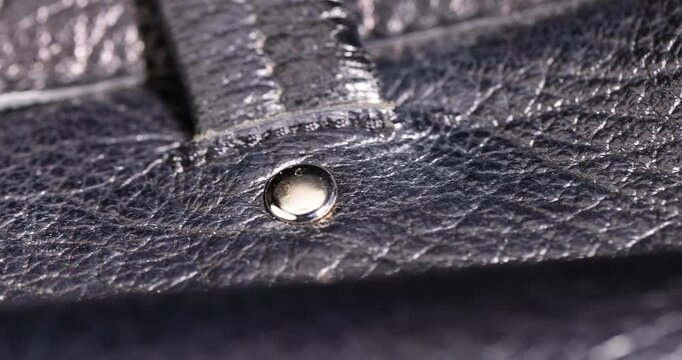 details of a natural black leather bag after prolonged use, details and pieces of natural leather used for the production of items, textile