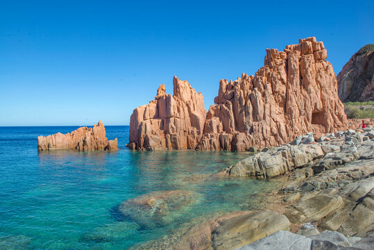 famous formation of red granite rock in  beautiful blue turquoise sea in Sardinia Italy - Rocce Rosse Arbatax